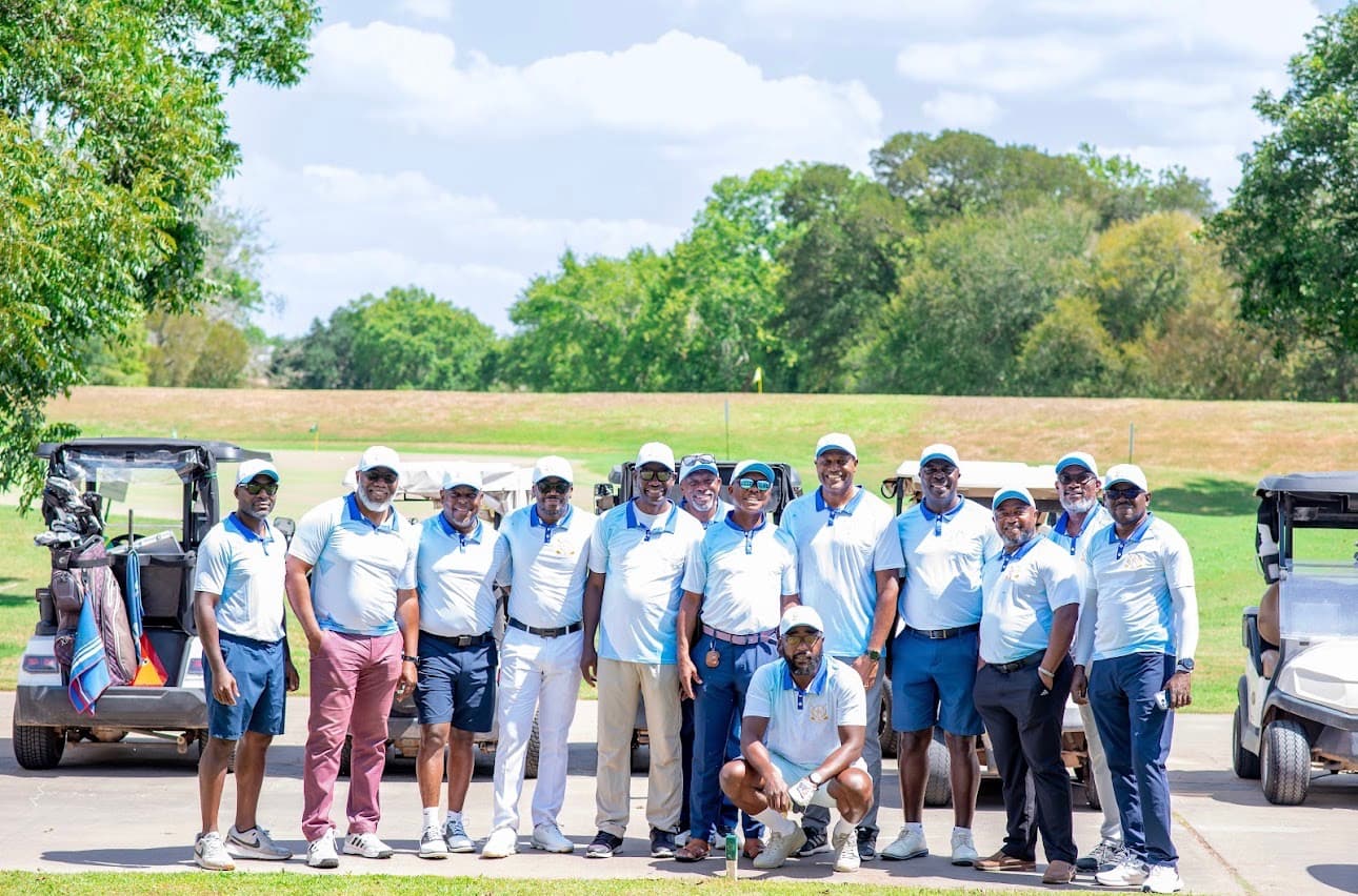 TAGA members posing with their golf carts on the course